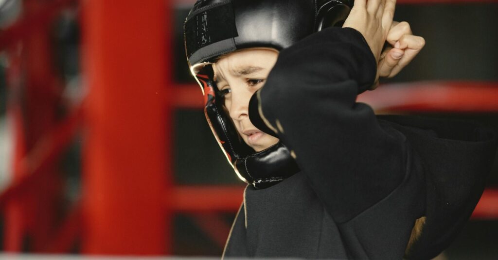 Young girl boxer waering open-face headgear for protection